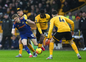 Newcastle United's Anthony Gordon is challenged by Wolves' Joao Gomes and Yerson Mosquera. Picture: PA