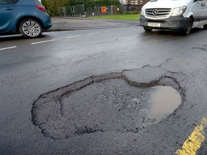 Supporting image for story: Pothole-ridden road finally being repaired one year after complaint