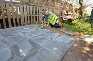 Danny Evans from Wates lays slabs for a shed