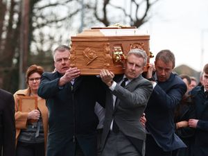 Patrick Kielty, right, carries the coffin of his mother Mary Kielty to the Church of the Sacred Heart in Dundrum for her funeral