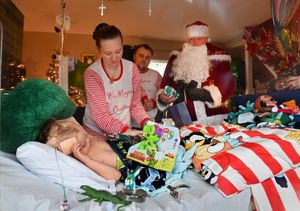 Peeping through the front window you can see Tommy with mom and dad and Santa..