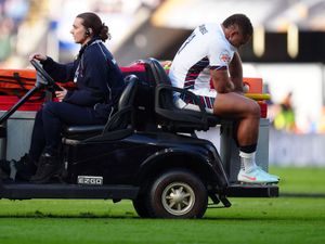 England’s Ollie Lawrence is driven off the pitch on the back of a cart after his injury against Italy