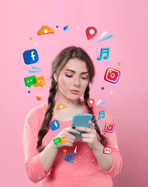 Teenage girl immersed in social media apps, highlighting the vibrant and ever-growing influence of digital platforms on everyday communication.
