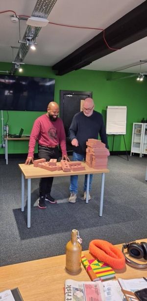 Quack Recruitment & Training Tutor, John, teaching basics of Wall Building. 