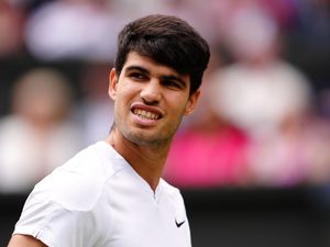 Carlos Alcaraz pulls a face on court