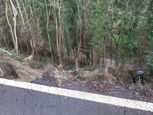 The road inches from the landslip