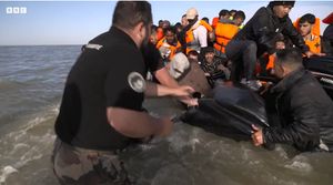 French authorities slashing the side of a boat being used by people thought to be migrants to cross the English Channel from France. (credit BBC)
