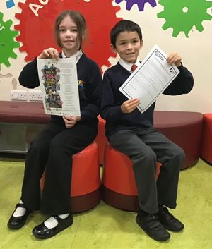 Year 4 pupils Elise Alexander and Federico Hudson with the poem and letter of thanks from poet Laura Mucha