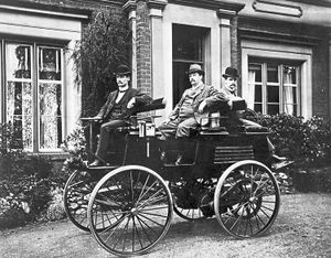 Thomas Parker, centre, in his electric car with his sons outside their home