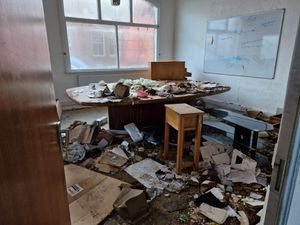 The conference room is covered in debris