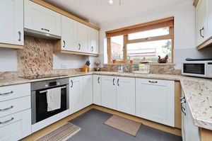 A well-proportioned kitchen with ample storage is supported by a separate utility room for everyday practicality