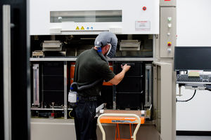Jason Holdbrook loading powder into a 3D printing machine