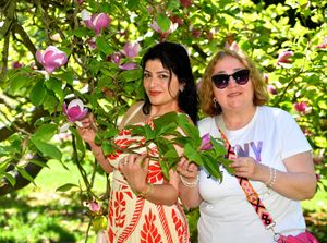 Friends Seda Yildizsabah and Sawleh Boramby take shade under a tree in Mary Stevens Park in Stourbridge. Photo: Tim Thursfield