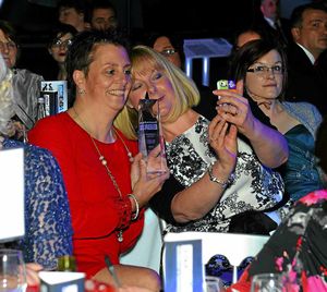 Michelle Byant and Sarah Nadin do a selfie with their award.