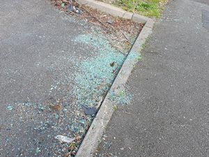 Supporting image for story: Driver 'absconds' after BMW crashes into parked minibus leaving debris strewn across road