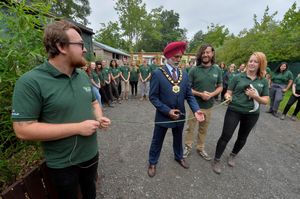 Telford & Wrekin mayor Amrik Jhawar cuts a long blade of grass to open the site
