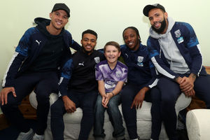 Kieran Gibbs, Darnell Furlong, Romaine Sawyers and Kyle Bartley with Harrison Eno, aged 10. Photo: AMA