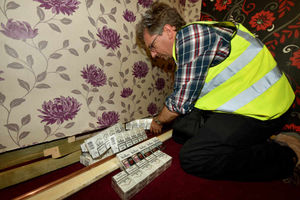 Cigarettes are discovered behind a fake wall
