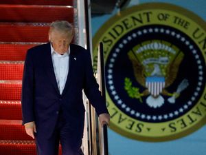 President Donald Trump walks down the stairs of Air Force One