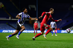 Tom Bayliss of Shrewsbury Town and Fisayo Dele-Bashiru of Sheffield Wednesday..