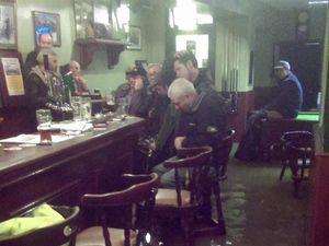 Supporting image for story: This lot didn’t let a minor inconvenience like flooding get in the way of their nightly beer