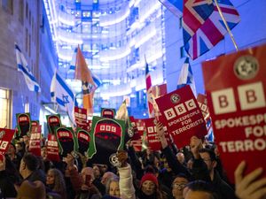 People take part in a protest outside Broadcasting House in central London