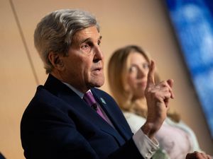 John Kerry gestures while speaking