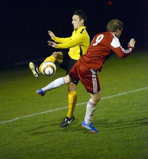 Ellesmere's Tim Jackson and Wem's Dan Price.
Elesmere in yellow