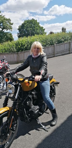 Mel in August 2022 after she just been out for a ride on her motorbike with her husband. Now she can't ride her motorbike because of her hip
