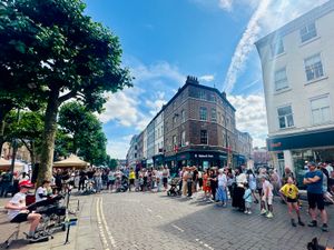 The SCARKEEZ, featuring Juno and Sam, performing to a large crowd on a sunny summer’s day.