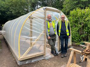 Jason Henley and Adrian Smith with the polytunnel.