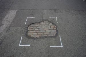 Pothole exposing cobbled streets on St Vincent Street in Birmingham