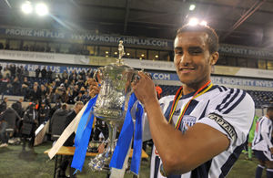 Captain James Hurst lifts the Birmingham Senior Cup for WBA