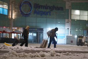 Holiday makers battle the snow leaving Birmingham Airport after all flights were cancelled after being hit by heavy snow. Heavy snow hits the Midlands causing chaos on the roads and at airports.