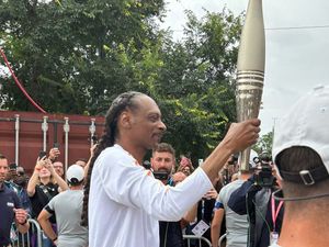 Supporting image for story: Crowds cheer as Snoop Dogg carries Olympic torch for Paris 2024 Games