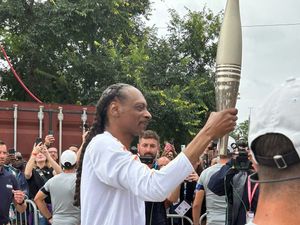 Supporting image for story: Crowds cheer as Snoop Dogg carries Olympic torch for Paris 2024 Games