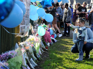 Hundreds of balloons were tied to the park fence