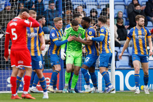 Marko Marosi of Shrewsbury Town is congratulated by his team mates after making a save (AMA)