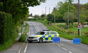 Police remain at the scene of the crash that killed three people