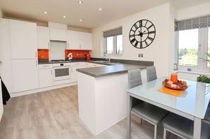 The modern kitchen diner is a well-lit space