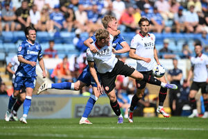 Jonny Stuttle challenges for the ball. (Image by Owen Russell)
