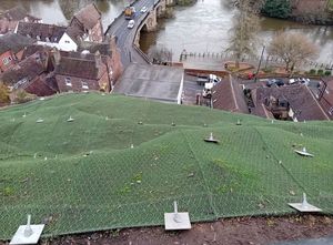 The netting to secure the embankment under the retaining wall