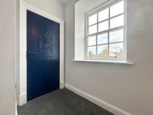 Doors in the apartment pay tribute to the building's former life as a police station