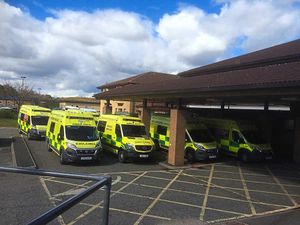 The scene outside the hospital as ambulances were forced to queue.
