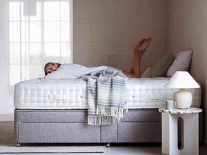 A woman lying on a Woolroom mattress