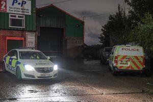 Police cars at the industrial estate where the men were killed. Photo: SnapperSK
