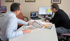 Editor Martin Wright, left, leads an editorial conference with others joining online