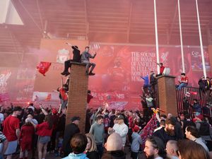 Liverpool fans celebrate victory in the Premier League