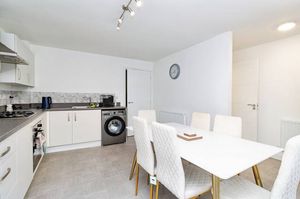 The contemporary kitchen has integrated units