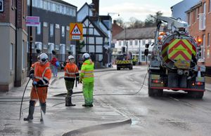 Council workers clear up the mess caused by the flooding in Coleham, Shrewsbury